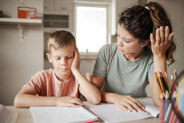 istock Upset Mother and Her Little Boy While Doing Homework at Home 1355346269