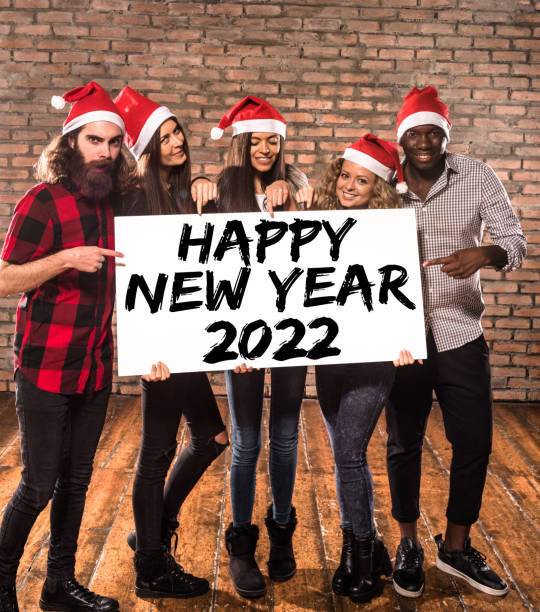 istock friends showing a billboard with santa hat 1355352253