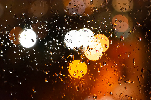 raindrops on glass in the background blurred city lights bokeh defocus