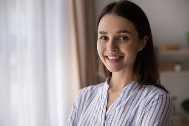 istock Head shot portrait confident smiling woman looking at camera 1355358103