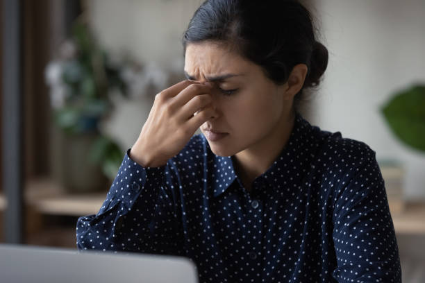 istock Close up Indian woman touching nose bridge, suffering from headache 1355358166