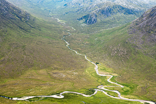 Two mountain rivers running down through mountain valleys in the Scottish Highlands  join together in a field of peat and heather before entering the lake Loch Na Sealga in the Fisherfield Forest area