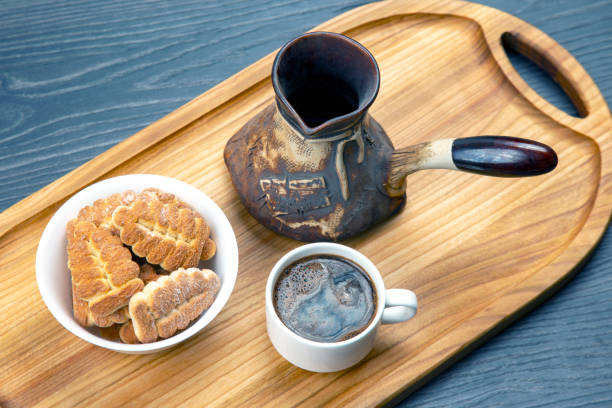istock fresh hot coffee with ceramic turkey and cookies on kitchen wooden board. 1355363312