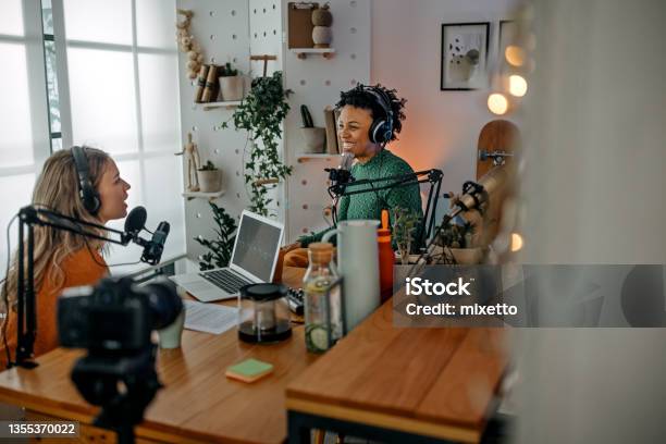 Two Young Women Recording Podcast Stock Photo - Download Image Now - Podcasting, Filming, Recording Studio