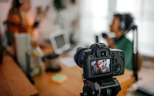 Photo of Camera recording women doing podcast