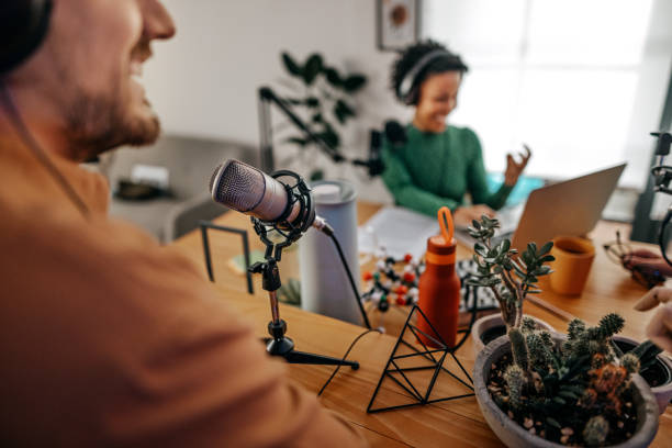 istock Young man and woman recording podcast 1355370177