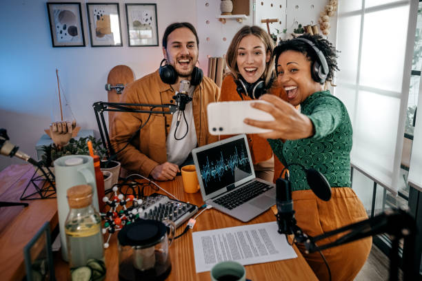 istock People taking picture after podcast recording 1355370256