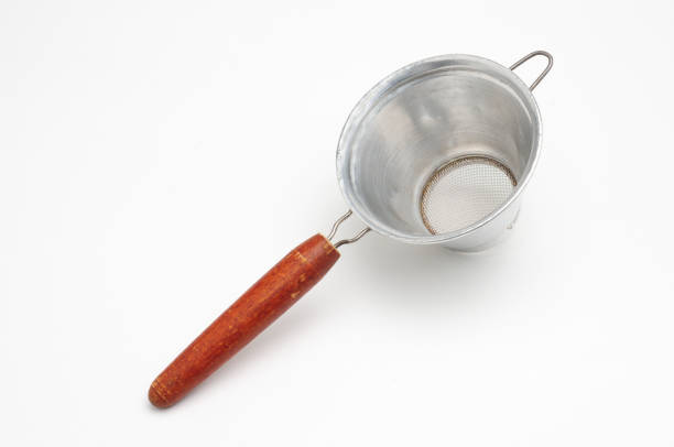 istock Vintage metal strainer for kitchen on white background 1355371147