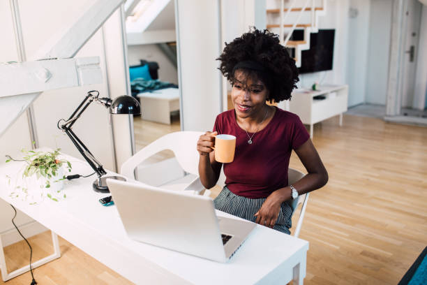 istock Young woman working online at her apartment 1355373084
