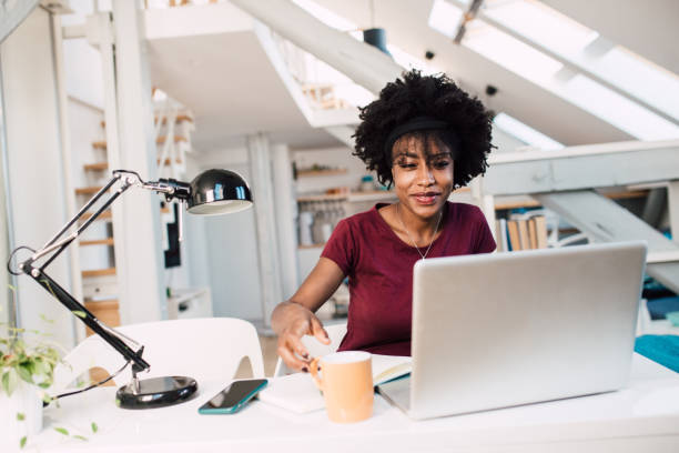 istock Young woman working online at her apartment 1355373089