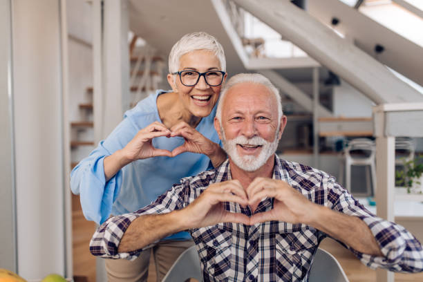 istock Happy senior entrepreneurs  showing hearts 1355373803