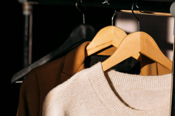 istock stylish beige clothes on a hanger 1355374813