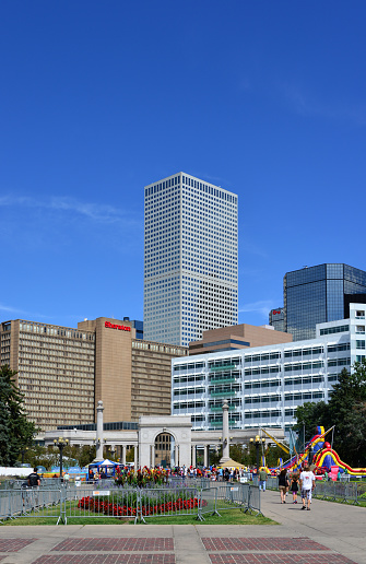 Denver, Colorado, USA: Republic Plaza tallest skyscraper in Colorado seen from the Civic Center Park with the Voorhies Memorial fountain, arch and colonnade - other central business district buildings, Sheraton Denver Downtown Hotel, Denver Post and Denver Energy Center.