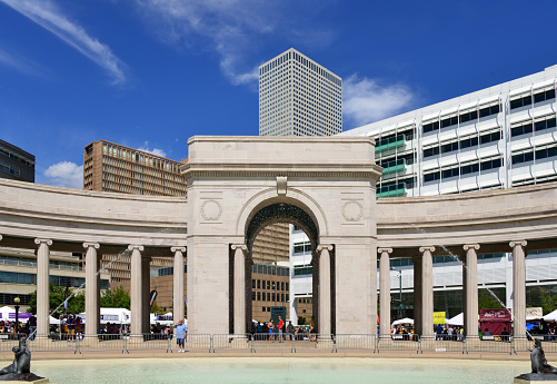 Denver, Colorado, USA: Civic Center Park, Denver's main square - Voorhies Memorial fountain, arch and colonnade, built in Turkey Creek sandstone - bronze seal statues designed by artist Robert Garrison (1921) - downtown office buildings including Republic Plaza, Sheraton Denver Downtown Hotel and Denver Post.