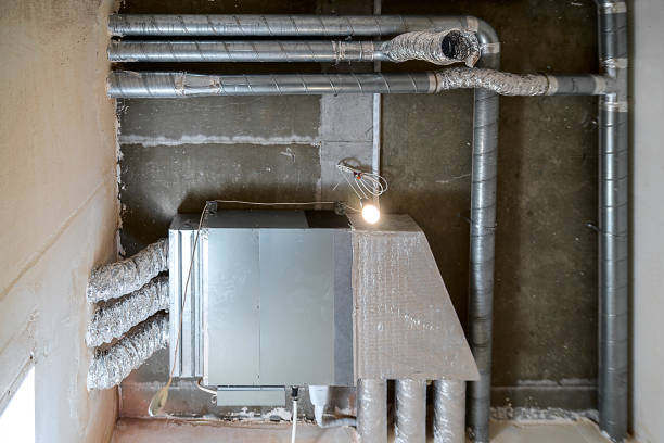 istock Wiring of ventilation pipes on a concrete ceiling in a house under construction. 1355376693
