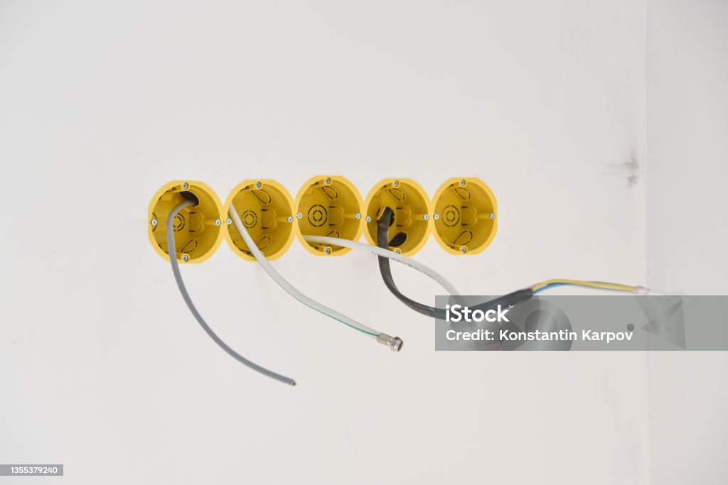 installation of yellow wall sockets with cable installation of yellow wall sockets with cable. Cable Stock Photo