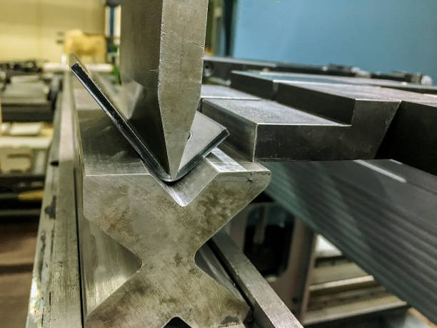 istock Bending sheet metal with a hydraulic bending machine 1355381909