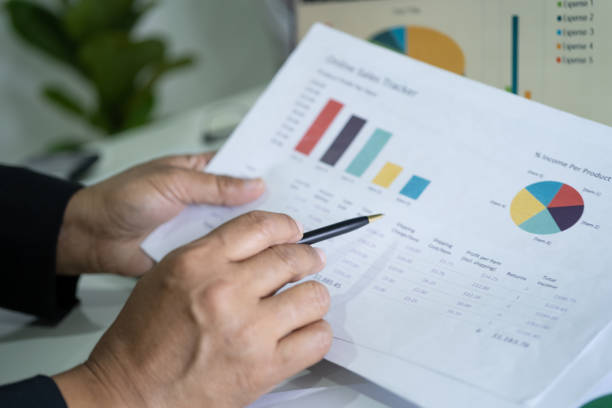 istock Asian accountant working and analyzing financial reports project accounting with chart graph and calculator in modern office, finance and business concept. 1355381946