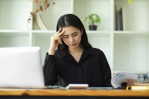 istock Stressed businesswoman working with laptop computer 1355399019