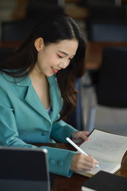 istock Successful female manager reading book, research some information 1355399089