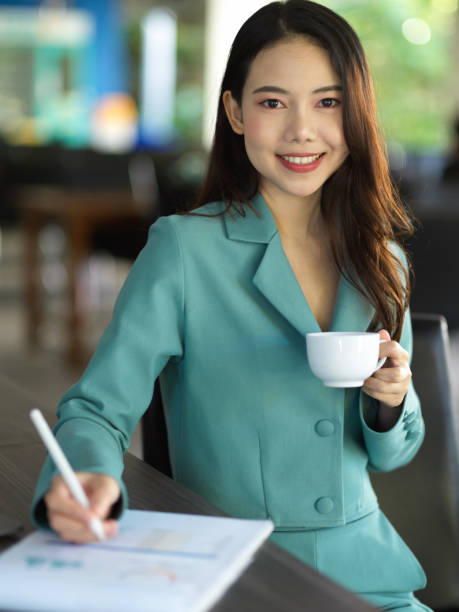 istock Female entrepreneur working at her office while sipping coffee. 1355399101