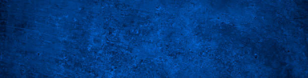 istock Dark blue abstract background. Toned concrete wall surface texture. Dark blue rough background 1355407653
