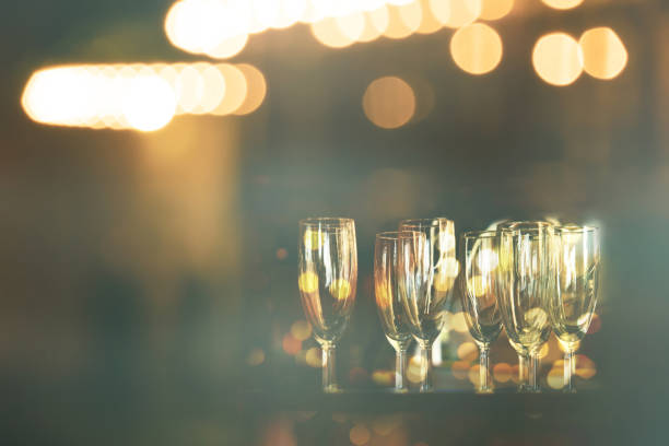 istock drinking glass in dark night bar party light background 1355409775