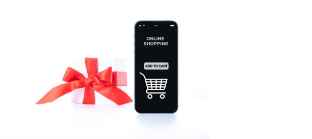 istock Christmas sale. Internet shop application on digital smartphone screen with gift box red ribbon in online shopping composition. Buy presents, prepare to xmas, among gift boxes and packages. 1355410419