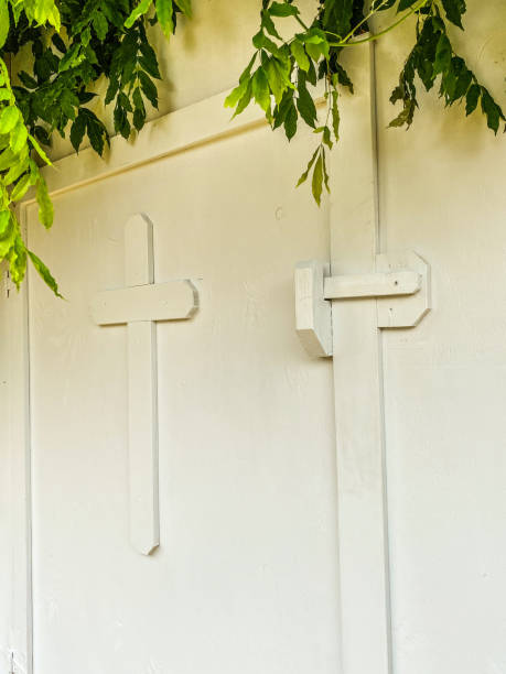istock White Cross with Wisteria Leaves 1355414609