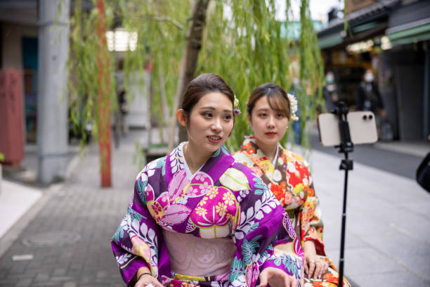 istock Young women in kimono vlogging at signtseeing place 1355414635
