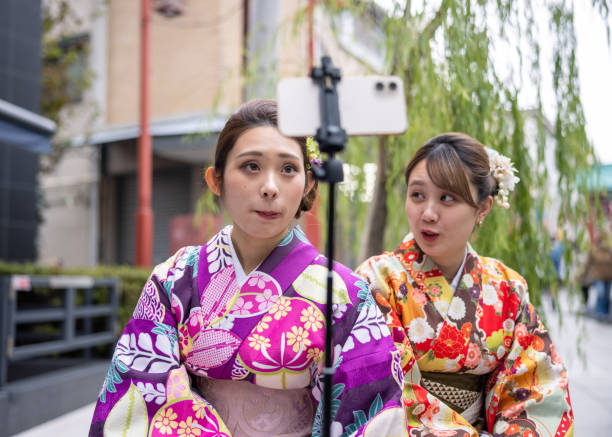 istock Young women in kimono vlogging at signtseeing place 1355414666