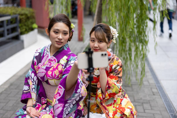 istock Young women in kimono vlogging at signtseeing place 1355414679