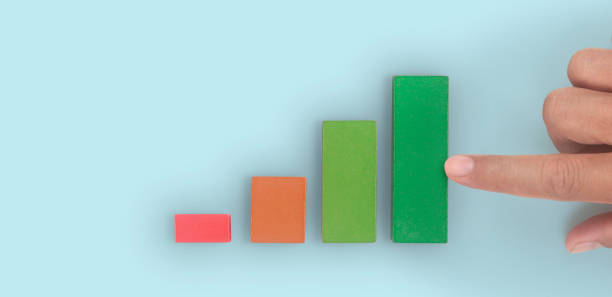 istock Business connecting piece of multi colored pie wood chart in hand 1355415764