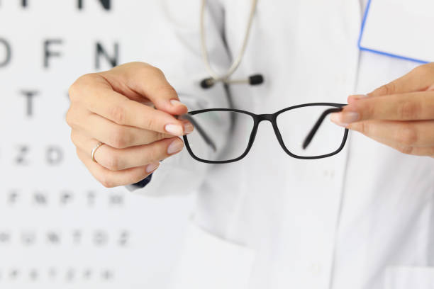 istock Doctor womans hands hold new glasses in optics 1355417142