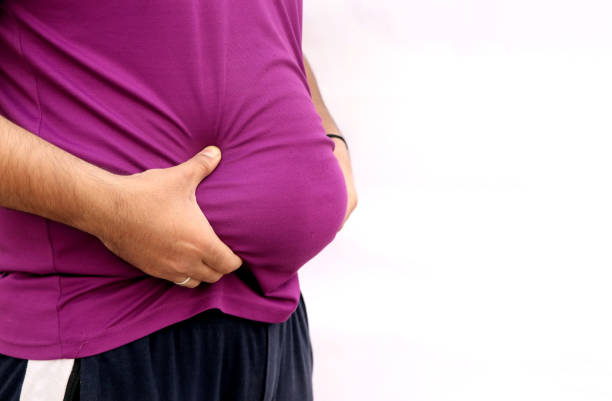 a portrait of a asian fat man show out his body and big belly. concept of obesity - overweight men people abdomen imagens e fotografias de stock