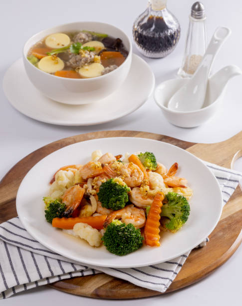 Stir fried vegetables with shrimps in a white dish