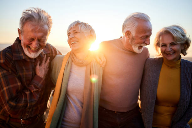 happy mature couples talking while walking in autumn day. - happy group imagens e fotografias de stock