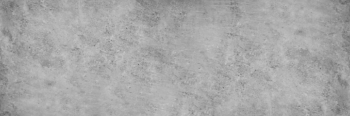 Gray concrete wall. Cement surface texture. Grunge background with copy space for design. Wide banner.