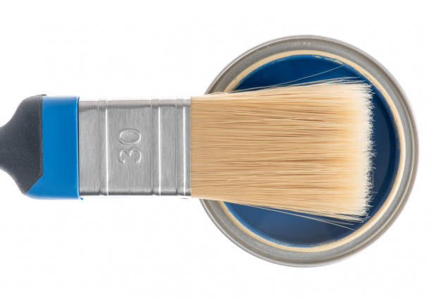 istock Opened can of blue paint with brush on white background 1355427303