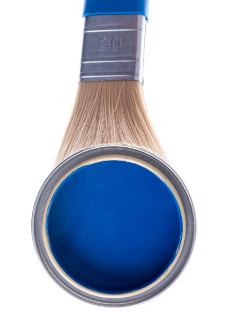istock Opened can of blue paint with brush on white background 1355427360
