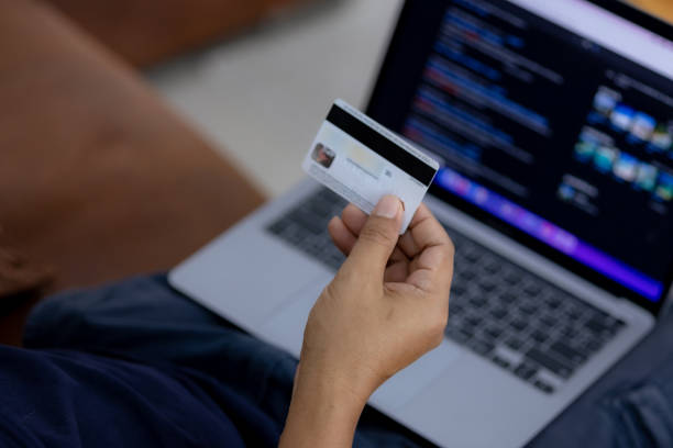 istock Asia men using credit card shopping online 1355428030