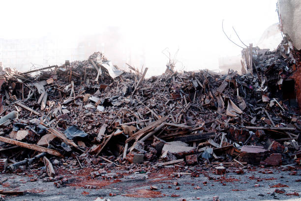 Pile of demolition rubble. Gray rubble at a building site. Demolition of a house. Concrete rubble debris on construction site