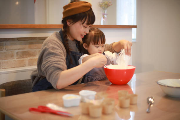 istock Parents and children making sweets 1355429954