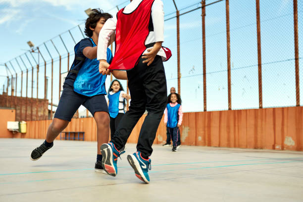 istock Active Schoolchildren Playing Tag Outdoors 1355430855