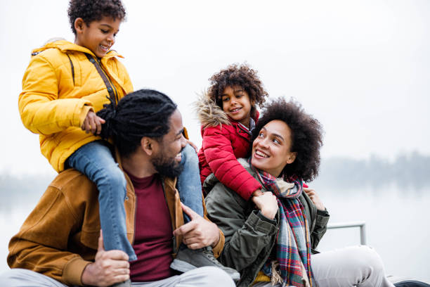 istock Happy black family spending a winter day at river. 1355430925