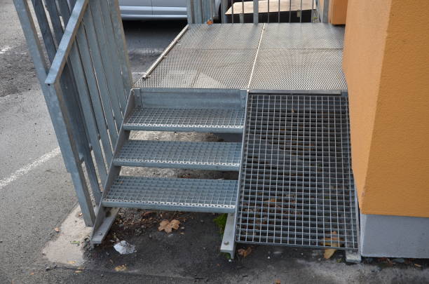 istock loading ramp at a restaurant or shop. galvanized staircase with railings and ramp with a lattice anti-slip ramp for the import of goods and food, or entry of immobile persons in wheelchairs 1355431016