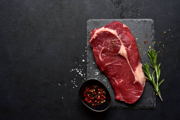 istock Raw organic rib eye steak with spices 1355432113