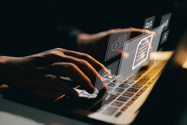 istock Businessman working on laptop computer with icons on virtual screen on office desk. Enterprise Resource Planning ERP, document management concept with icons on virtual screen. 1355432229