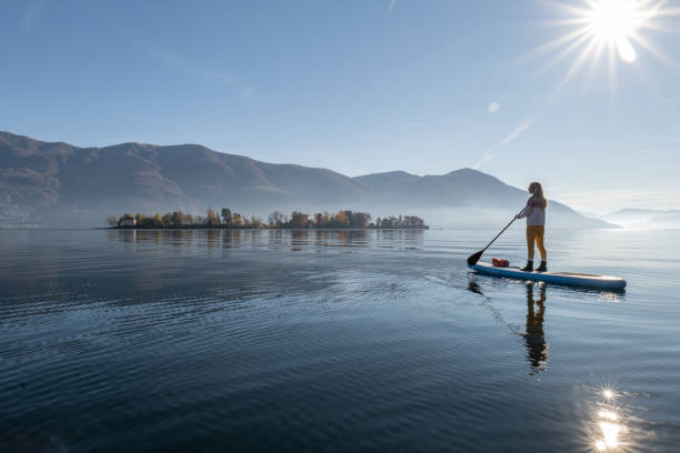 istock Woman paddling on a stand up paddle board 1355433092