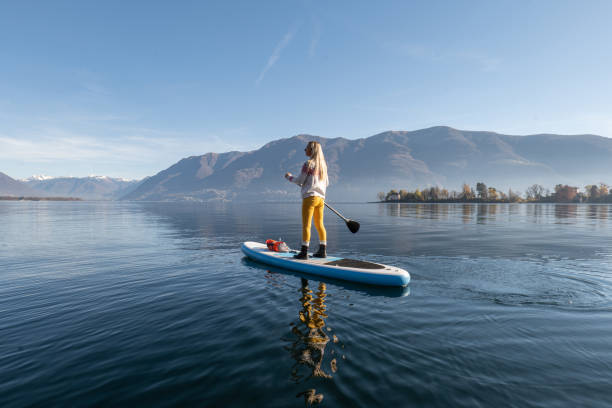 istock Woman paddling on a stand up paddle board 1355433153